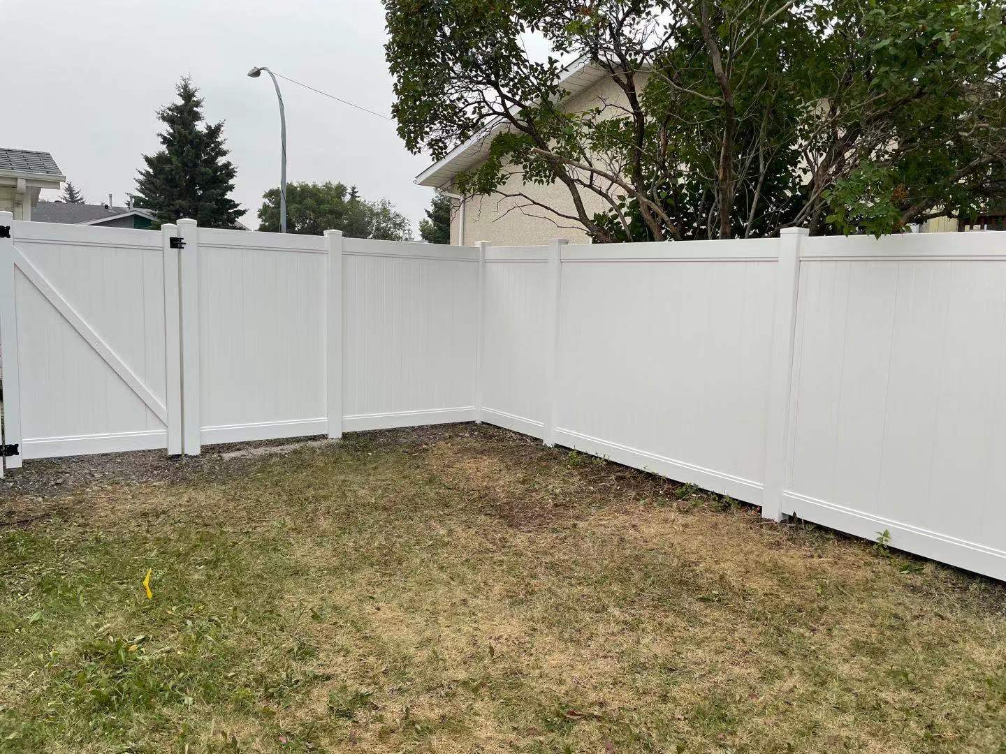 a newly constructed wood fence in the backyard