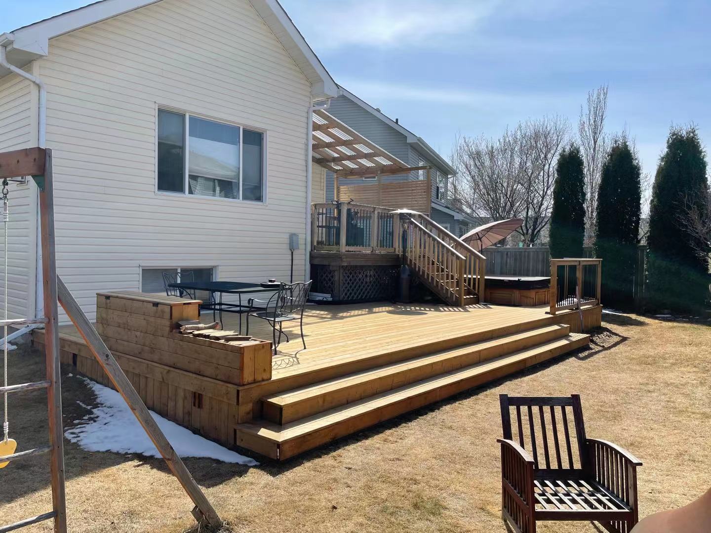 a newly constructed wood deck in the backyard