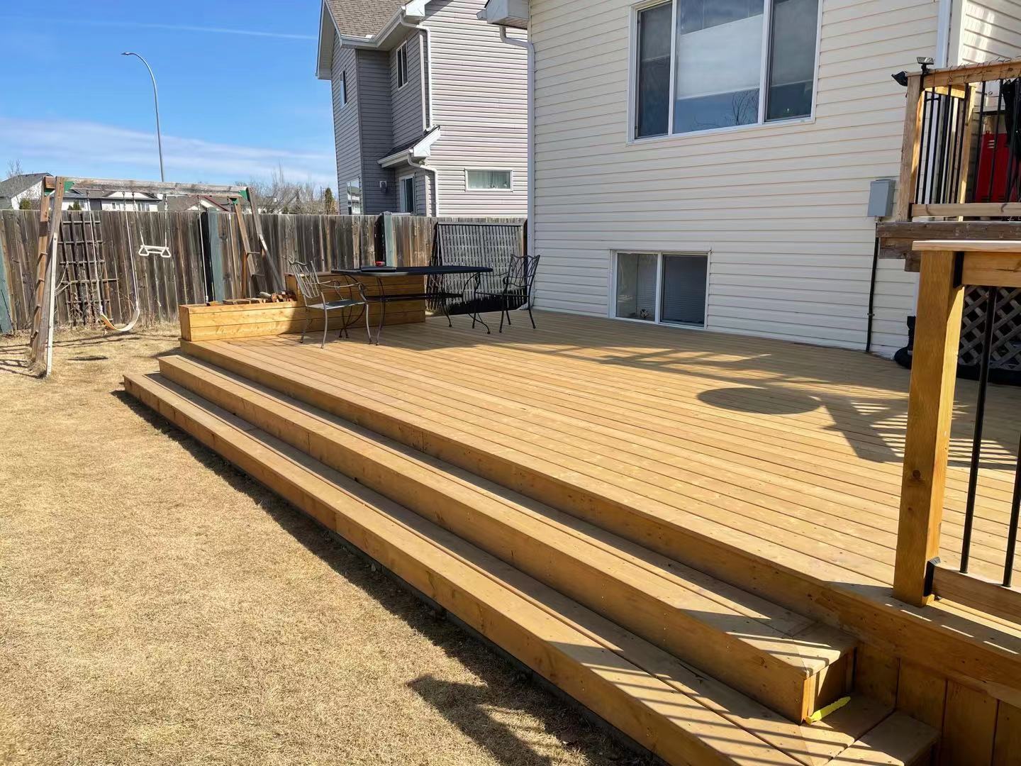 a newly constructed wood deck in the backyard